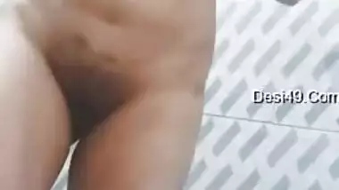 Big-tittied Desi gal strips and XXX pleases herself with fingering